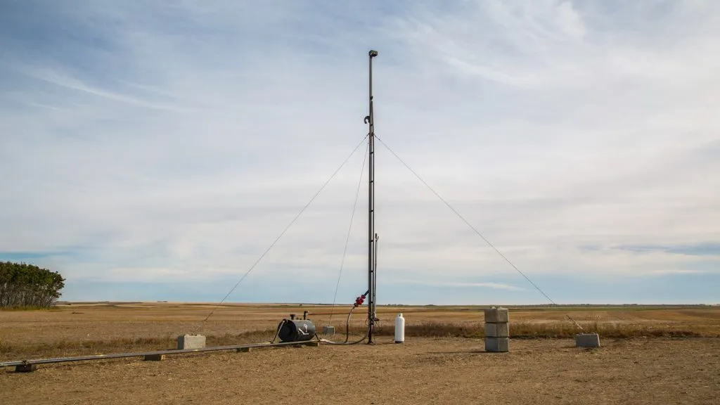 guyed rental flare stacks in alberta - Fully erected guy-wired rental flare stack complete with knockout drum and pilot gas setup in an Alberta oilfield.