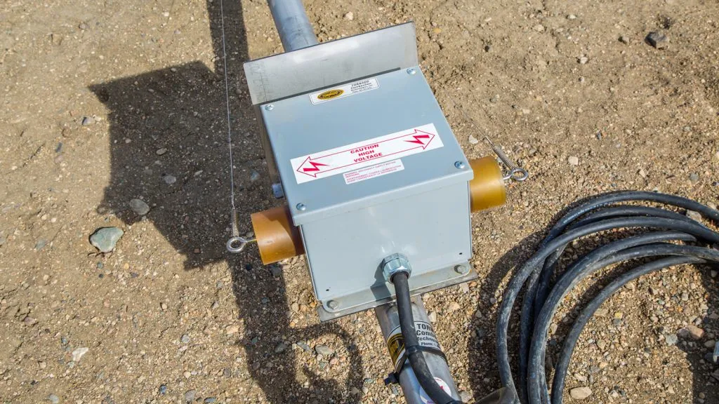 High-voltage ignition transformer box mounted on a Tornado rental flare stack in Alberta.